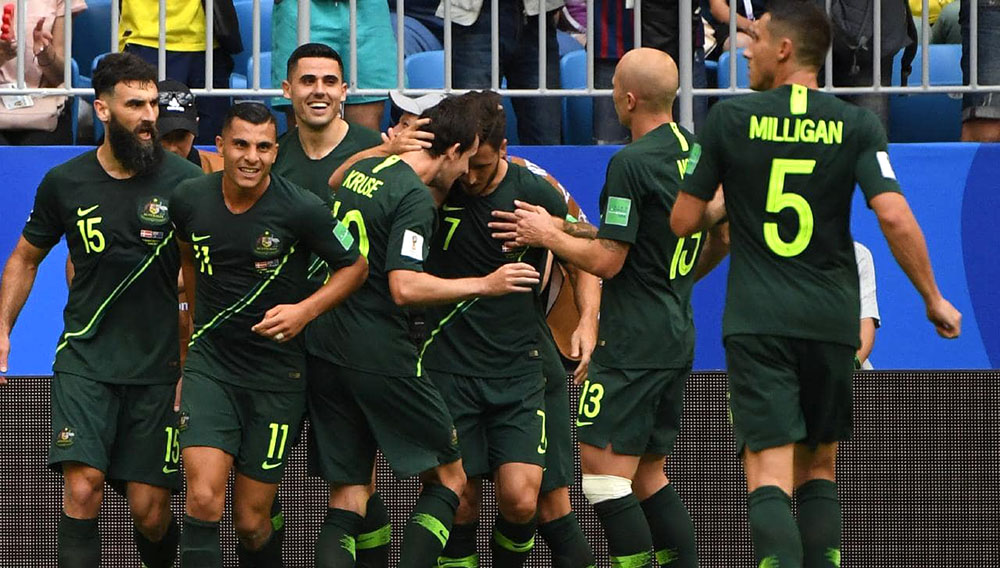 Australia celebrate Mile Jedinak's penalty goal equaliser.