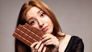 Portrait of the young girl with big chocolate