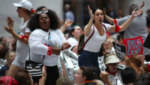 WASHINGTON, DC - JUNE 28: Protesters that marched from Freedom Plaza to the U.S. Capitol demonstrate inside the Hart Senate Office Building against family detentions and to demand the end of criminalizing efforts of asylum seekers and immigrants June 28, 2018 in Washington, DC. More than 1,000 women from 47 states took part in the march, with numerous arrests taking place during the sit-in at the Senate office building. Win McNamee/Getty Images/AFP