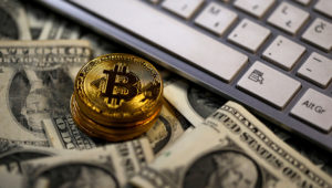 FILE PHOTO: Bitcoin (virtual currency) coins placed on Dollar banknotes, next to computer keyboard, are seen in this illustration picture, November 6, 2017. REUTERS/Dado Ruvic/Illustration/File Photo