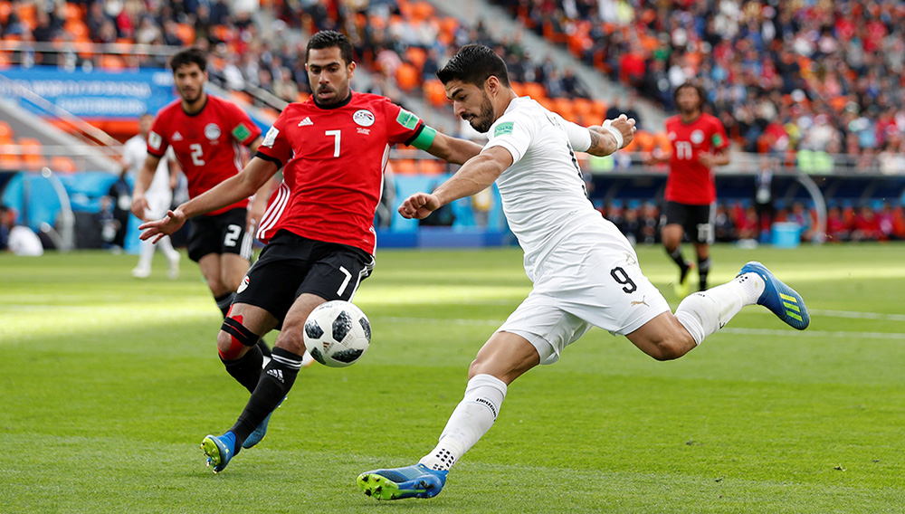 Uruguay's Luis Suarez in action with Egypt's Ahmed Fathy.