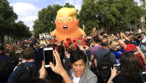 A protest against President Trump in London's Parliament Square includes a giant balloon of "Trump Baby" in a diaper on Friday. It flew high above the statutes of prominent historical figures including Winston Churchill, Mahatma Gandhi and Millicent Fawcett. AMER GHAZZAL / BARCROFT MEDIA VIA GETTY IMAGES