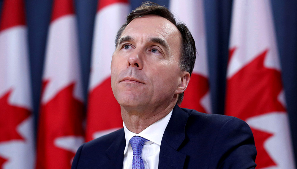 FILE PHOTO: Canada's Finance Minister Bill Morneau listens to a question during a news conference about the state of the Kinder Morgan pipeline expansion in Ottawa, Ontario, Canada, May 16, 2018. REUTERS/Chris Wattie/File Photo