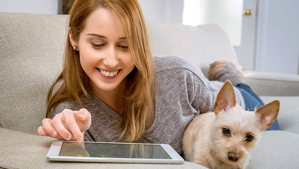 Woman with tablet and dog