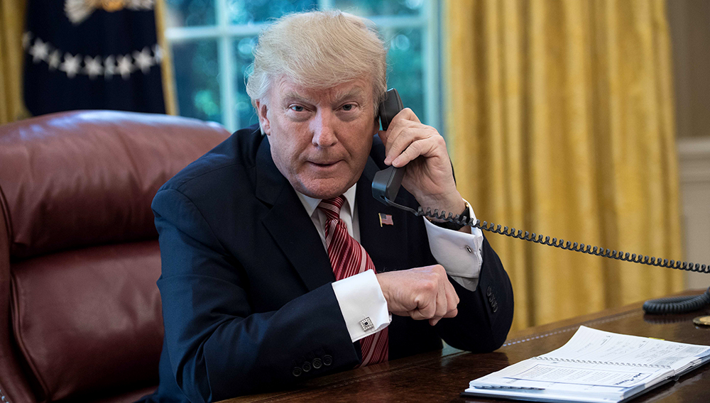 US President Donald Trump waits to speak on the phone with Irish Prime Minister Leo Varadkar to congratulate him on his recent election victory in the Oval Office at the White House in Washington, DC, on June 27, 2017. / AFP PHOTO / NICHOLAS KAMM (Photo credit should read NICHOLAS KAMM/AFP/Getty Images)