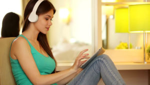 Teenager with tablet listening music