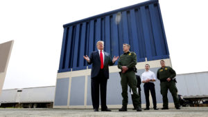 President Donald Trump speaks during a tours as he reviews border wall prototypes, Tuesday, March 13, 2018, in San Diego, as Rodney Scott, the Border Patrol’s San Diego sector chief, listens. (AP Photo/Evan Vucci)