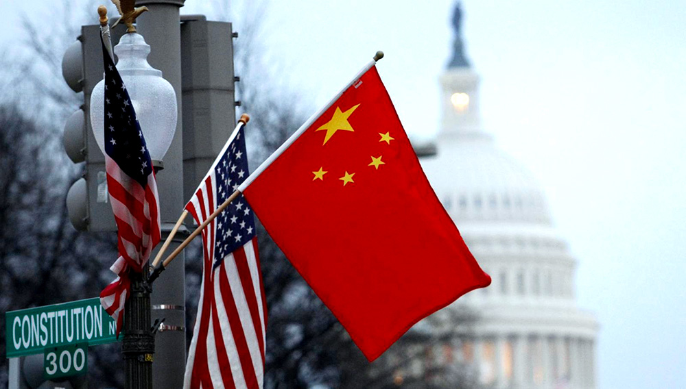 The People's Republic of China flag and the U.S. Stars and Stripes fly on a lamp post along Pennsylvania Avenue near the U.S. Capitol during Chinese President Hu Jintao's state visit, in Washington, D.C., U.S., January 18, 2011. REUTERS/Hyungwon Kang/File Photo