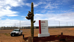 A cactus and sign mark the entrance to the Eloy Detention Facility for illegal immigrants on July 30, 2010 in Eloy, Arizona. (Photo by John Moore/Getty Images)