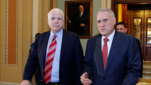 Senators John McCain (L) and Jon Kyl leave the Senate chamber to caucus in the US Capitol on December 30, 2012 in Washington, DC. SOURCE: MOLLY RILEY/AFP/Getty Images