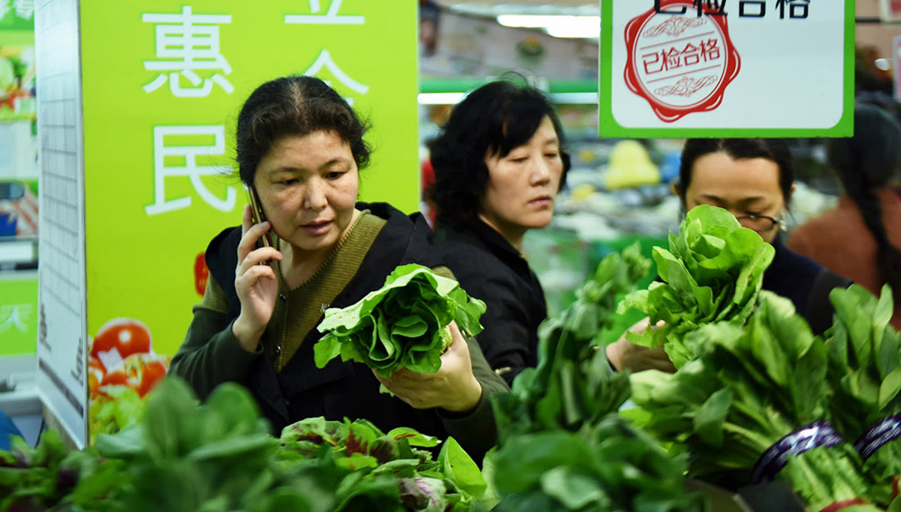 A customer shops for vegetables at a supermarket in Hangzhou, Zhejiang Province. Chinese consumers are tightening their purse strings as mortgages weigh heavily on their finances. (Getty Images)