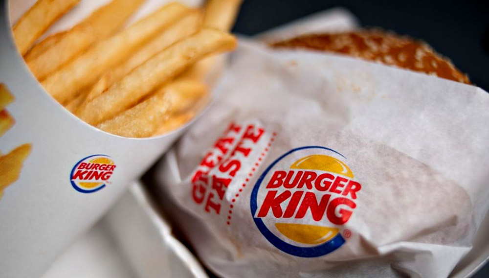 A Burger King Whopper hamburger is arranged with french fries for a photograph in Tiskilwa, Illinois, U.S., on Wednesday, Feb. 13, 2013. Burger King Worldwide Inc., the second largest fast food hamburger chain in the world, is scheduled to release quarterly earnings on Feb. 15. Photographer: Daniel Acker/Bloomberg via Getty Images