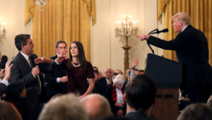 Jim Acosta initially refused to hand over the microphone to a White House member of staff, as he attempted to ask Donald Trump a follow-up question © Reuters