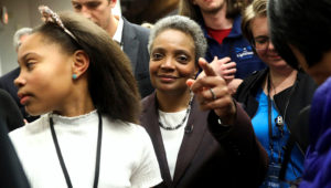 Mayoral candidate Lori Lightfoot and her daughter Vivian Lightfoot appear with supporters at EvolveHer in Chicago Tuesday, Feb. 26, 2019. Former federal prosecutor Lightfoot, who could become the first African-American woman to lead the nation's third-largest city, was the top vote-getter in a field of 14 that included a member of the Daley family that has dominated Chicago politics for much of the last six decades. (Erin Hooley/Chicago Tribune via AP)
