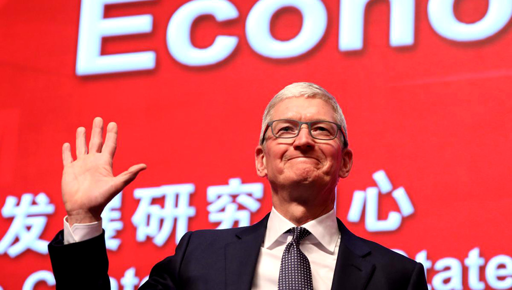 Apple CEO Tim Cook waves as he arrives for the Economic Summit held for the China Development Forum in Beijing on March 23, 2019. (AFP)