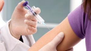 Administering vaccine proper placement. | Photostock