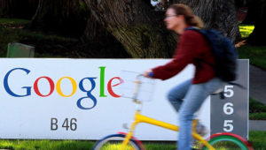 A bicyclist rides by a sign at the Google headquarters in Mountain View, Calif. (Photo: Justin Sullivan, Getty Images)