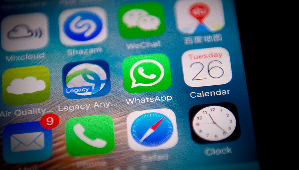 This photo illustration shows the Whatsapp application logo (C) on a smartphone screen in Beijing on September 26, 2017. / AFP PHOTO / NICOLAS ASFOURI (Photo credit should read NICOLAS ASFOURI/AFP/Getty Images)