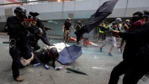 A riot police officer fires pepper-spray projectile toward anti-government protesters demonstrating near the Legislative Council building in Hong Kong, China, September 29, 2019. | REUTERS/Athit Perawongmetha