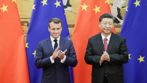 Chinese President Xi Jinping and French President Emmanuel Macron stand in front of Chinese and EU flags at a signing ceremony inside the Great Hall of the People on Nov. 6 in Beijing. © Getty Images