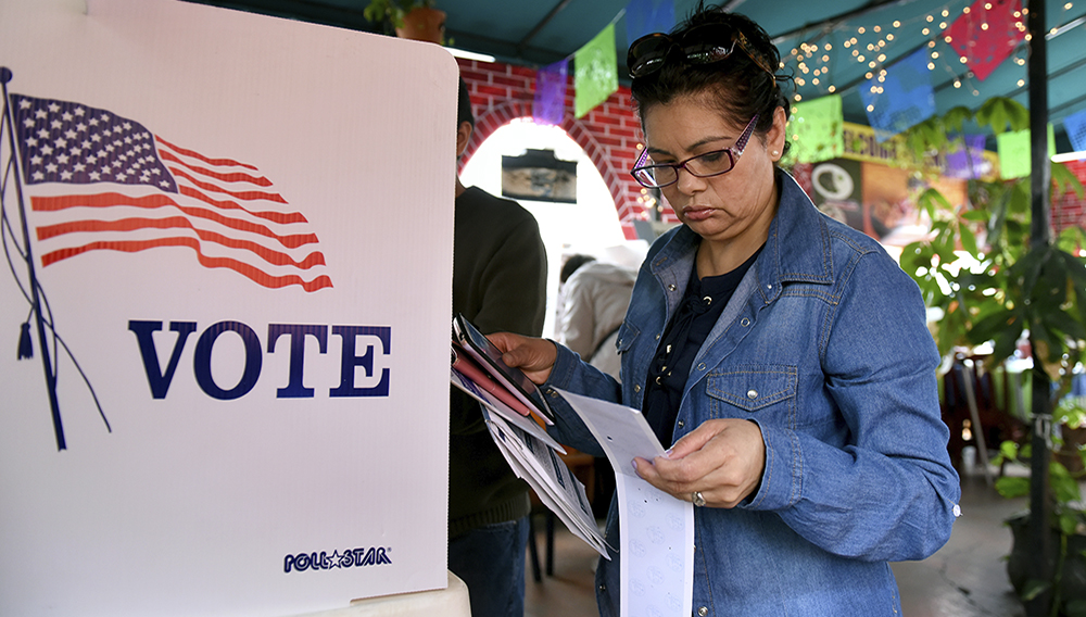 Rosa Ayala checks her ballot after voting in the US presidential primary June 7, 2016 at Sabores de Oaxaca, a Mexican restaurant in Los Angeles, California. (MICHAEL OWEN BAKER/AFP/Getty Images)