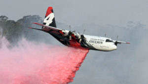 A C-130 Hercules drops water over bushfires in New South Wales. Credit: AFP