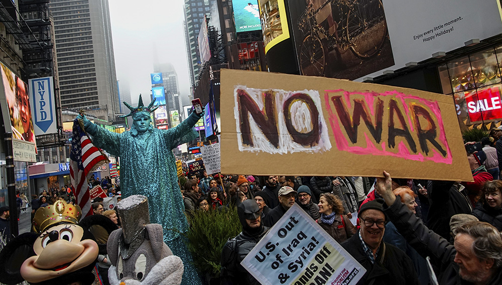 People march as they take part in an anti-war protest amid increased tensions between the United States and Iran at Times Square in New York, U.S., January 4, 2020. REUTERS/Eduardo Munoz