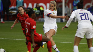 U.S. midfielder Lindsey Horan scores past Canada defender Kadeisha Buchanan during the second half of a CONCACAF women’s Olympic qualifying soccer match Sunday, Feb. 9, 2020, in Carson, Calif. The U.S. won 3-0. Photo: Chris Carlson, The Associated Press.