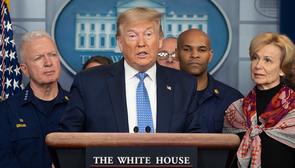US President Donald Trump standing with members of the White House Coronavirus Task Force team, speaks during a press briefing in the press briefing room of the White House March 15, 2020 in Washington, DC. (Photo by JIM WATSON/AFP via Getty Images)