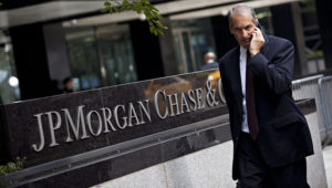 A man walks past JP Morgan Chase's international headquarters on Park Avenue in New York July 13, 2012. REUTERS/Andrew Burton