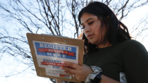 Karina Shumate, 21, a college student studying stenography, fills out a voter registration form in Richardson, Texas, Saturday, Jan. 18, 2020. Democrats are hoping this is the year they can finally make political headway in Texas and have set their sights on trying to win a majority in one house of the state Legislature. (AP Photo/LM Otero)