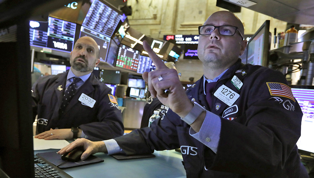 Specialists James Denaro, left, and Mario Picone work on the floor of the New York Stock Exchange, Tuesday, March 10, 2020. Stocks, Treasury yields and oil are clawing back some of the plunge they took a day before, when the S&P 500 had its worst drop in more than a decade. (AP Photo/Richard Drew)