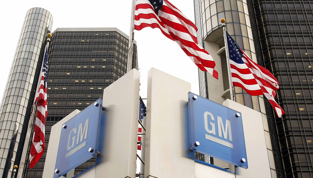 Signs stand in front of the General Motors world headquarters complex November 18, 2010 in Detroit, Michigan. GM returned to selling its newly issued stock to the public today as they resumed trading on the NYSE. The stock sales are expected to generate approximately $23 billion for General Motors. (Photo by Bill Pugliano/Getty Images)