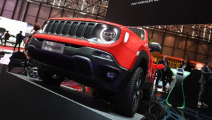 A Jeep Renegade 4x4 e is presented at the Geneva Motor Show March 5, 2019. Signage in the background says”’FCA Fiat Chrysler Automobiles,” to which Jeep belongs. Uli Deck | picture alliance | Getty Images