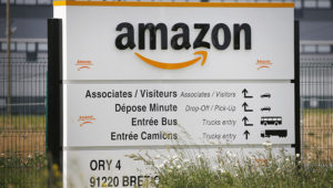 The logo of Amazon is seen at the entrance of the company logistics center on April 21, 2020 in Bretigny-sur-Orge, France. (Photo by Chesnot/Getty Images)
