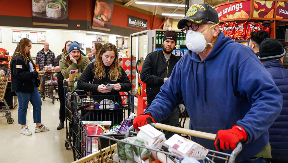 SAN FRANCISCO CA - MARCH 17: Mike Schwinn (right) and others wait In line to check out their purchases at the Safeway supermarket on 7th Avenue on Tuesday, March 17, 2020 in San Francisco, California. The city is in lockdown due to the coronavirus. (Gabrielle Lurie/The San Francisco Chronicle via Getty Images)