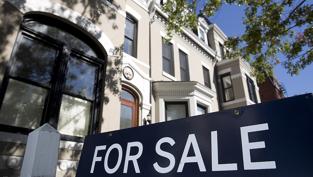 A "For Sale" stands outside of a property in Washington, D.C., U.S., on Friday, oct. 17, 2014. The National Association of Realtors is scheduled to release existing home sales figures on oct. 21. Photographer: Andrew Harrer/Bloomberg via Getty Images