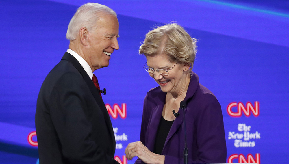 Democratic presidential candidate former Vice President Joe Biden, left, talks with Sen. Elizabeth Warren, D-Mass., during a Democratic presidential primary debate hosted by CNN/New York Times at Otterbein University, Tuesday, Oct. 15, 2019, in Westerville, Ohio. (AP Photo/John Minchillo)