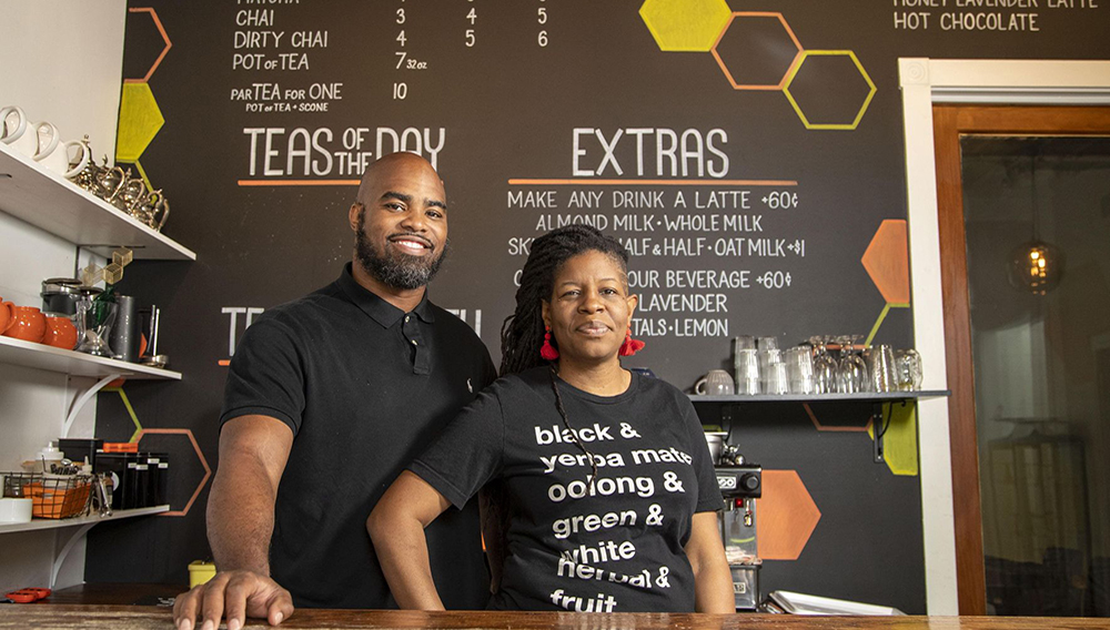 In this April 30, 2020 photo, Just Add Honey Tea Company owners Brandi and Jermail Shelton pose for a photo at their shop in Atlanta. They have switched their business focus to online orders during the COVID-19 pandemic. (Alyssa Pointer/Atlanta Journal-Constitution via AP)
