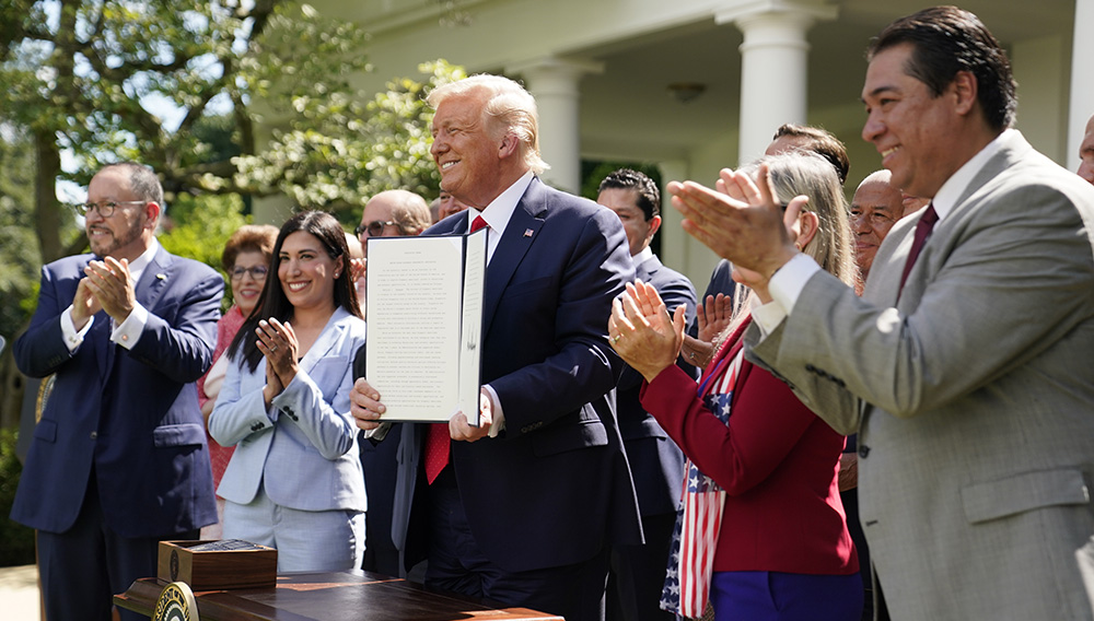 President Donald Trump holds an executive order on the "White House Hispanic Prosperity Initiative," after signing it in the Rose Garden of the White House, Thursday, July 9, 2020, in Washington. (AP Photo/Evan Vucci)