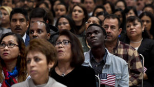 Immigrants listen to a speech as they wait to become U.S. citizens at a naturalization ceremony in Los Angeles. (Mark Ralson/AFP/Getty Images)