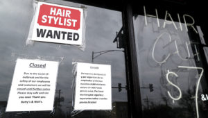 FILE - In this April 30 ,2020 file photo, a barber shop shows closed and hiring sign during the COVID-19 in Chicago. On Thursday, Aug. 27, just over 1 million Americans applied for unemployment benefits last week, a sign that the coronavirus outbreak continues to threaten jobs even as the housing market, auto sales and other segments of the economy rebound from a springtime collapse. (AP Photo/Nam Y. Huh, File)