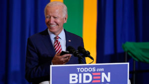 Democratic presidential candidate former Vice President Joe Biden plays music on a phone as he arrives to speak at a Hispanic Heritage Month event, Tuesday, Sept. 15, 2020, at Osceola Heritage Park in Kissimmee, Fla. (AP Photo/Patrick Semansky)