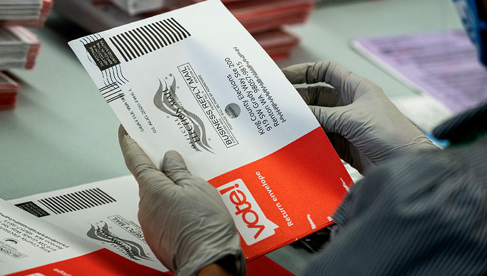RENTON, WA - AUGUST 04: An elections worker opens ballots at the King County Elections headquarters on August 4, 2020 in Renton, Washington. Today is election day for the primary in Washington state, where voting is done almost exclusively by mail. (Photo by David Ryder/Getty Images)