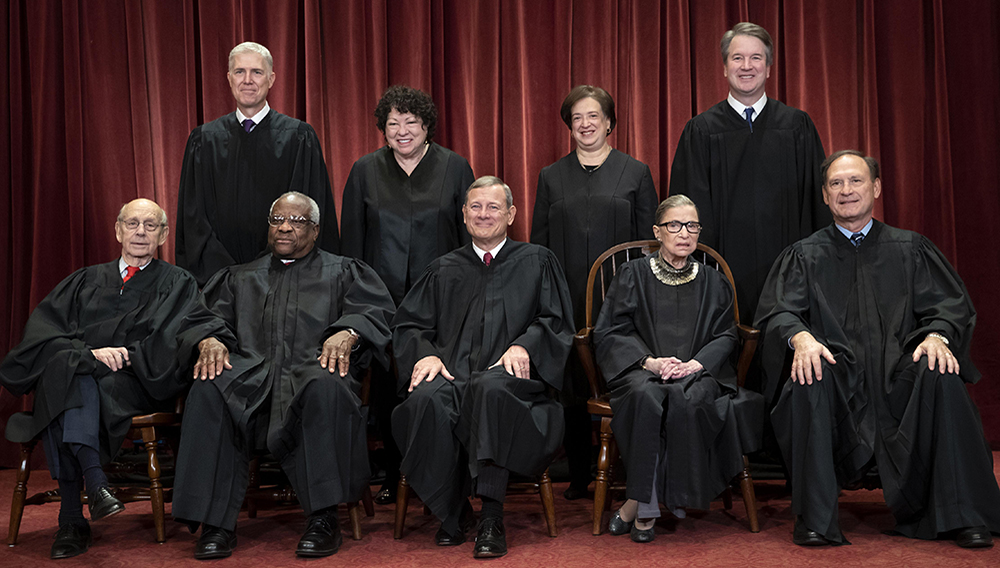 FILE - In this Nov. 30, 2018, file photo, the justices of the U.S. Supreme Court gather for a formal group portrait to include the new Associate Justice, top row, far right, at the Supreme Court building in Washington. Seated from left: Associate Justice Stephen Breyer, Associate Justice Clarence Thomas, Chief Justice of the United States John G. Roberts, Associate Justice Ruth Bader Ginsburg and Associate Justice Samuel Alito Jr. Standing behind from left: Associate Justice Neil Gorsuch, Associate Justice Sonia Sotomayor, Associate Justice Elena Kagan and Associate Justice Brett M. Kavanaugh. (AP Photo/J. Scott Applewhite, File)