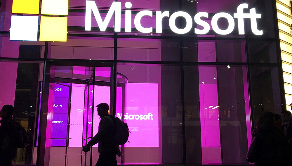 FILE - In this Nov. 10, 2016, file photo, people walk past a Microsoft office in New York. Microsoft said Thursday, Sept. 10, 2020, that the same Russian military intelligence outfit that hacked the Democrats in 2016 has been trying to break into more than 200 organizations in recent weeks, including political parties and consultants. (AP Photo/Swayne B. Hall, File)