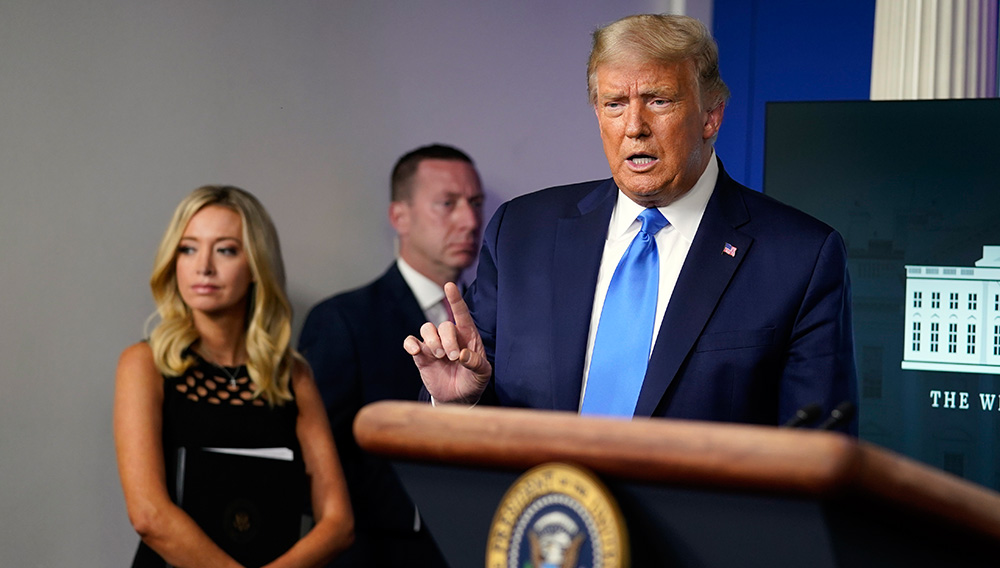President Donald Trump speaks during a news conference in the James Brady Press Briefing Room of the White House Wednesday in Washington, as White House press secretary Kayleigh McEnany listens. EVAN VUCCI/ASSOCIATED PRESS