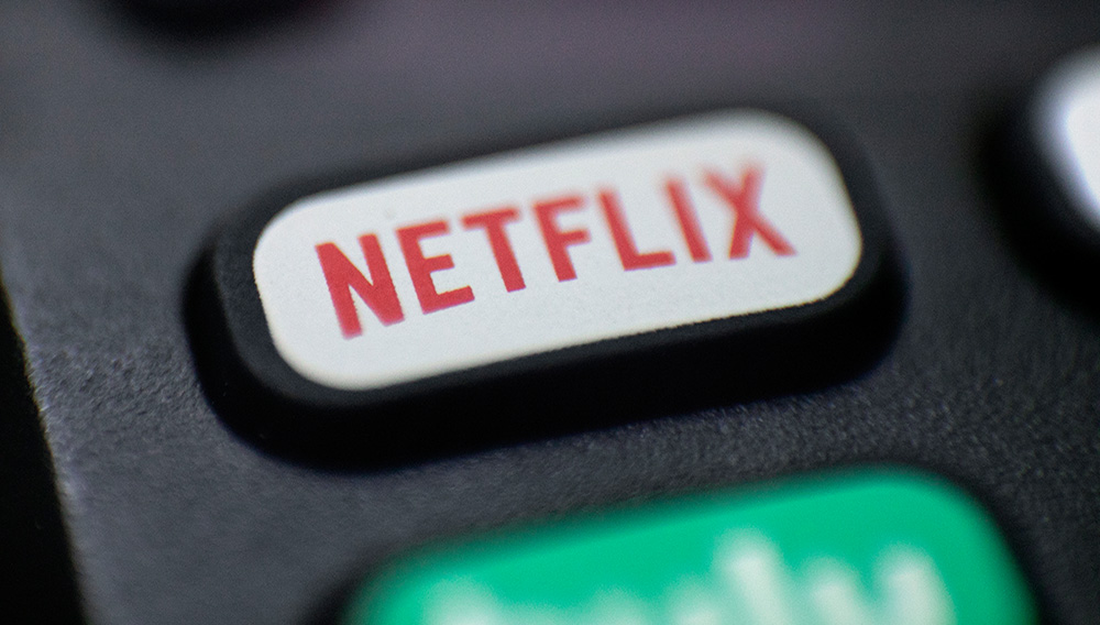 FILE - This Aug. 13, 2020 file photo shows a logo for Netflix on a remote control in Portland, Ore. Netflix is raising most of its U.S. prices by 8% to 13% as its video streaming service rides a wave of rising popularity spurred by government-imposed lockdowns that corralled people at home during the fight against the pandemic. (AP Photo/Jenny Kane, File)