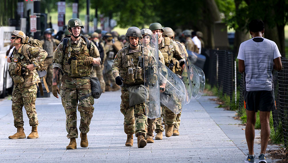 US military troops disembark from tour buses as they deploy inside the security perimeter at the White House as the George Floyd and police brutality protests continue in Washington on June 4. | Getty Images