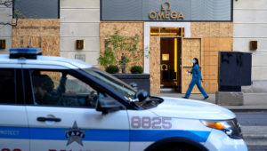 Plywood covers the windows of an Omega store in Chicago, Illinois, U.S. October 13, 2020. Chicago police have warned local retailers to prepare for possible protests around Election Day. REUTERS/Moe Zoyari